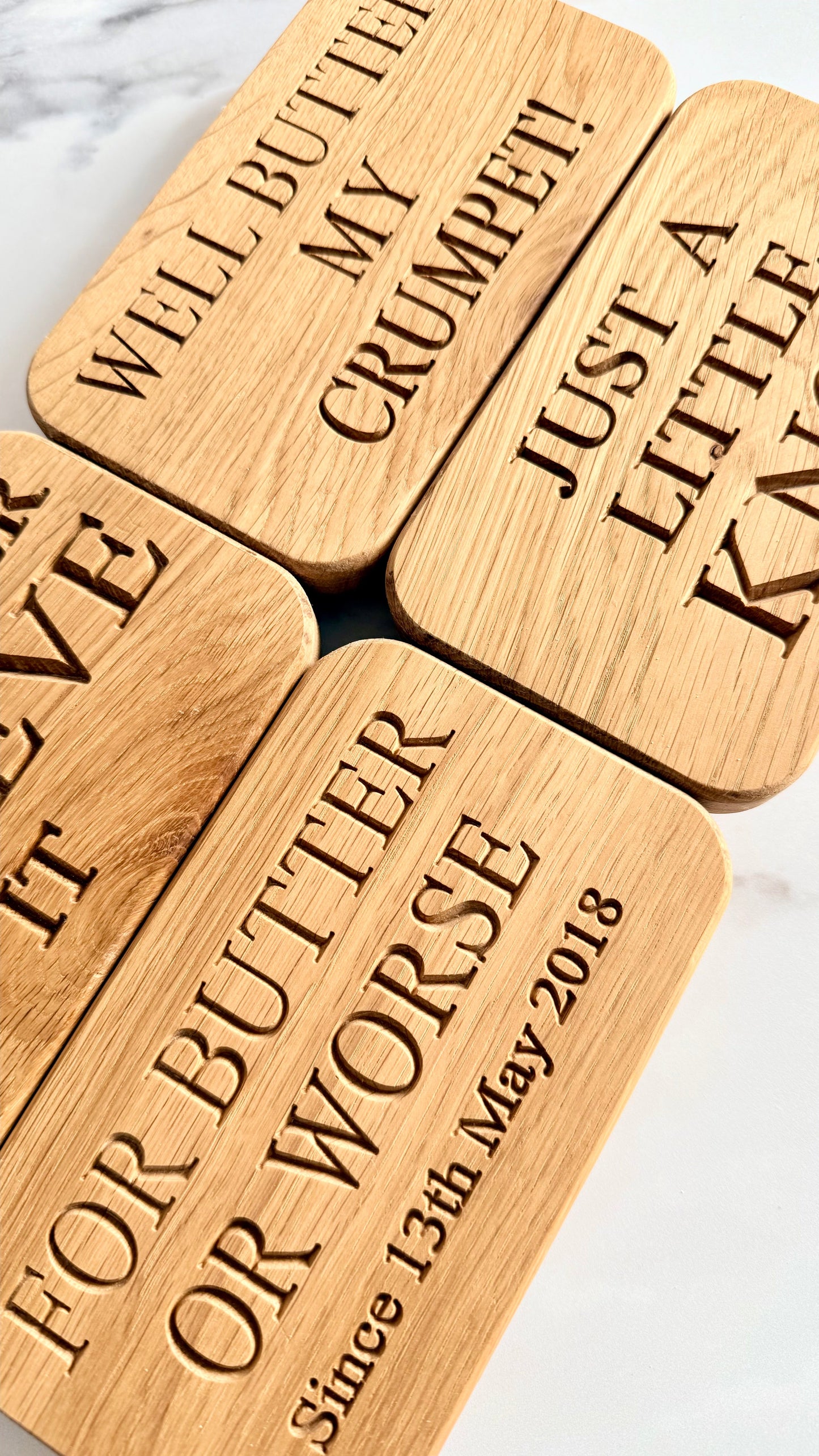Wooden blocks with engraved text on a marble surface
