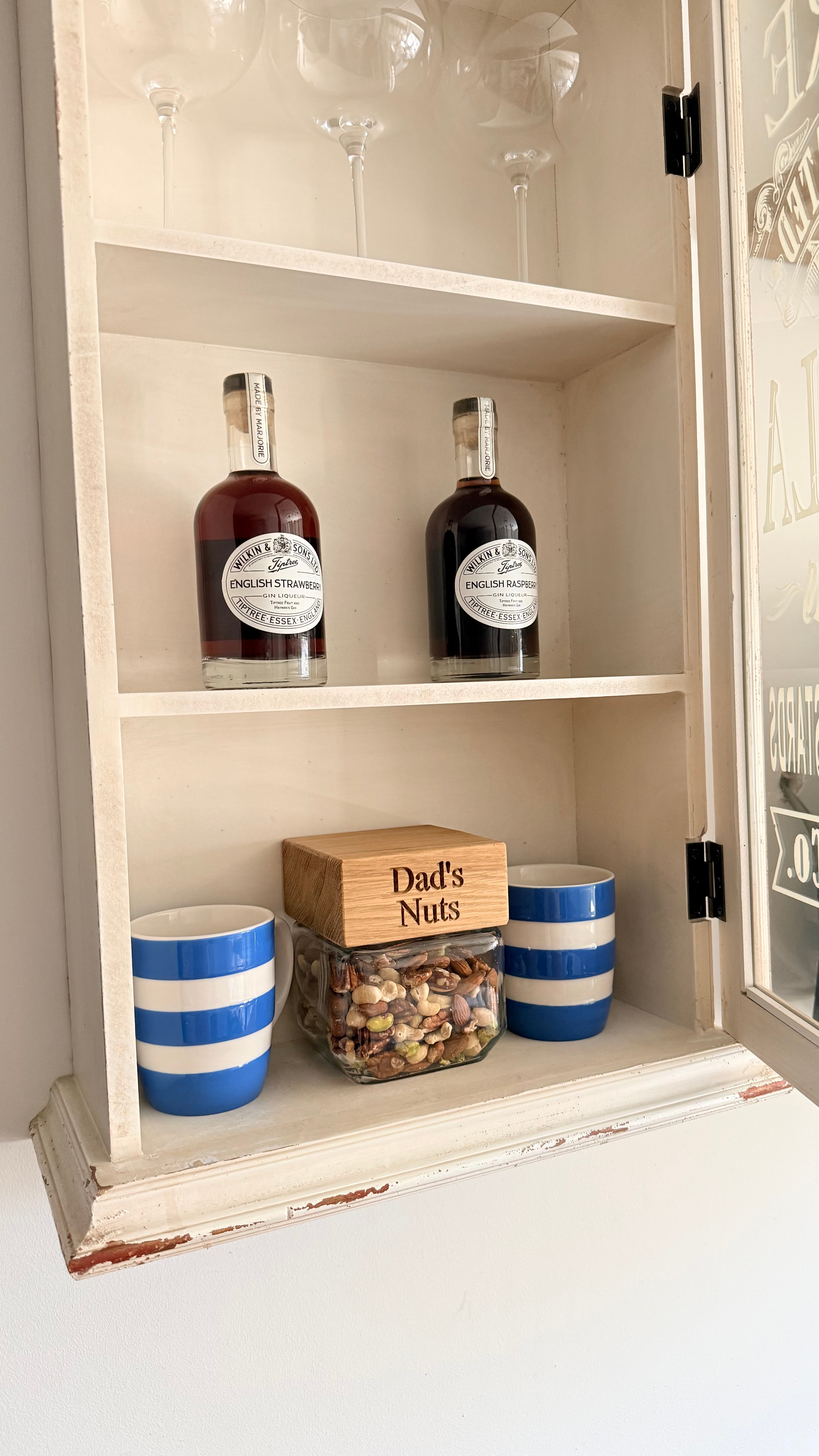 Handmade glass storage jar filled with mixed nuts and finished with a personalised FSC-certified oak lid engraved “Dad’s Nuts”