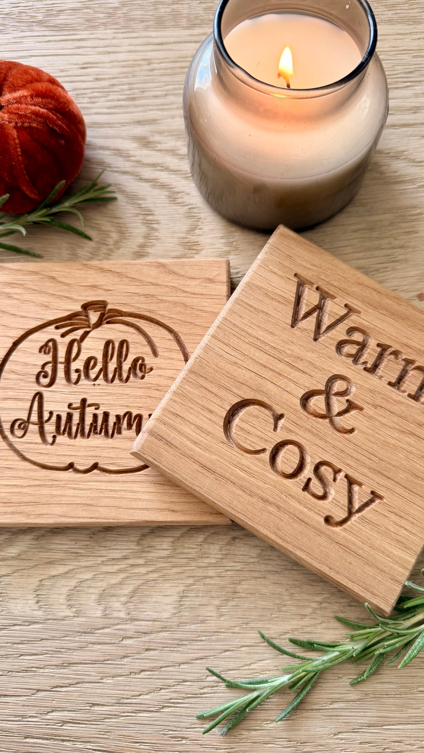 Close-up of handmade solid oak autumn coaster showing natural oak grain and engraved design