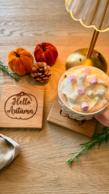 Warm & Cosy engraved oak coaster styled with hot chocolate, marshmallows and autumn pumpkins