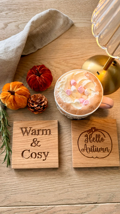 Handmade oak autumn coaster set styled with pumpkins, pine cones and a cosy hot chocolate